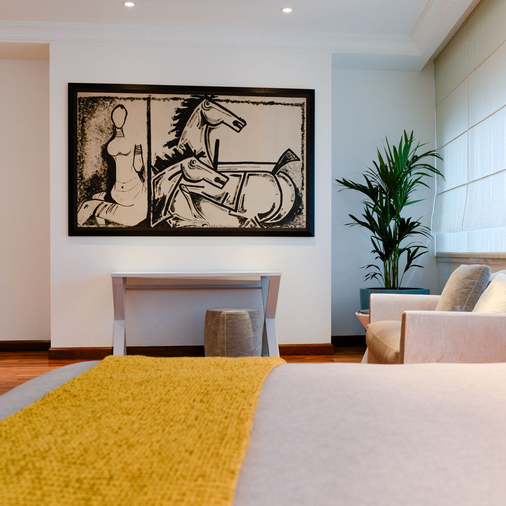 A bedroom with a sitting area