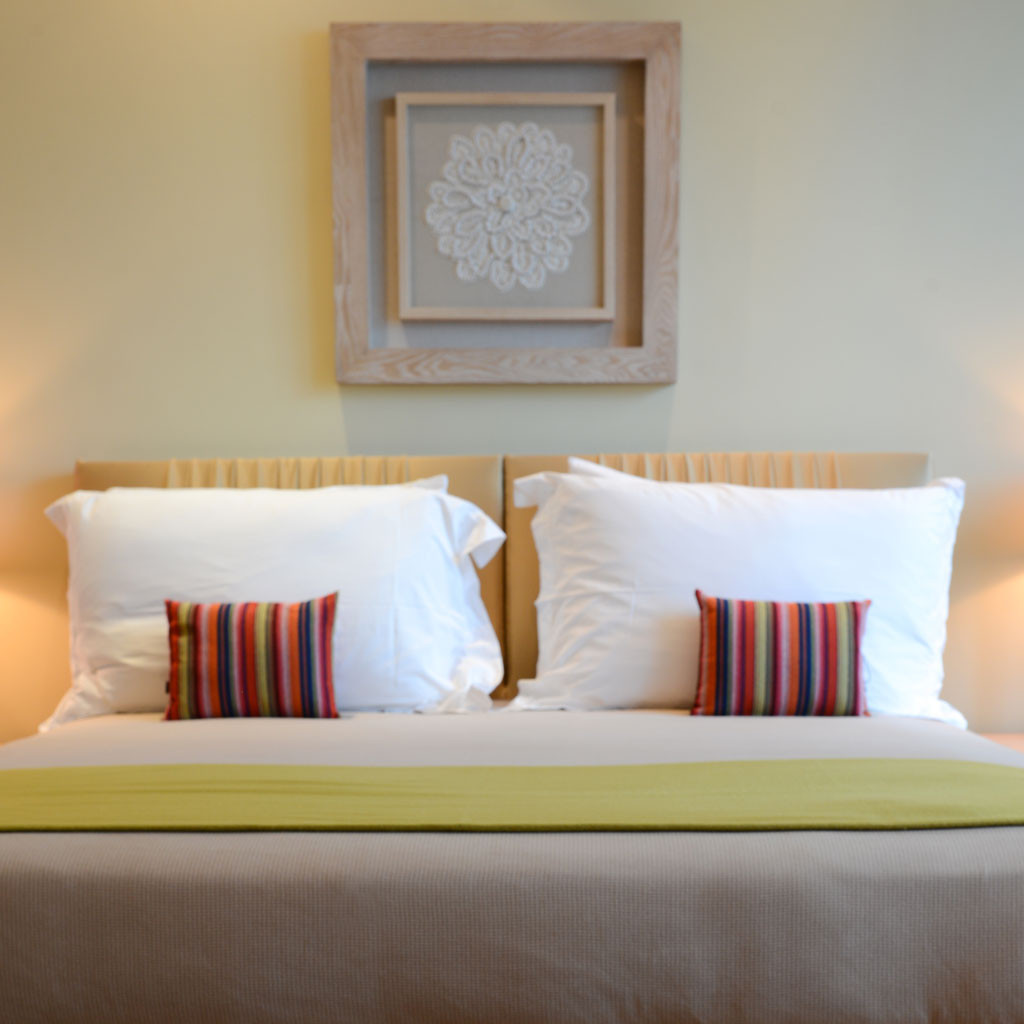 A cute bedroom with a brigh color accent