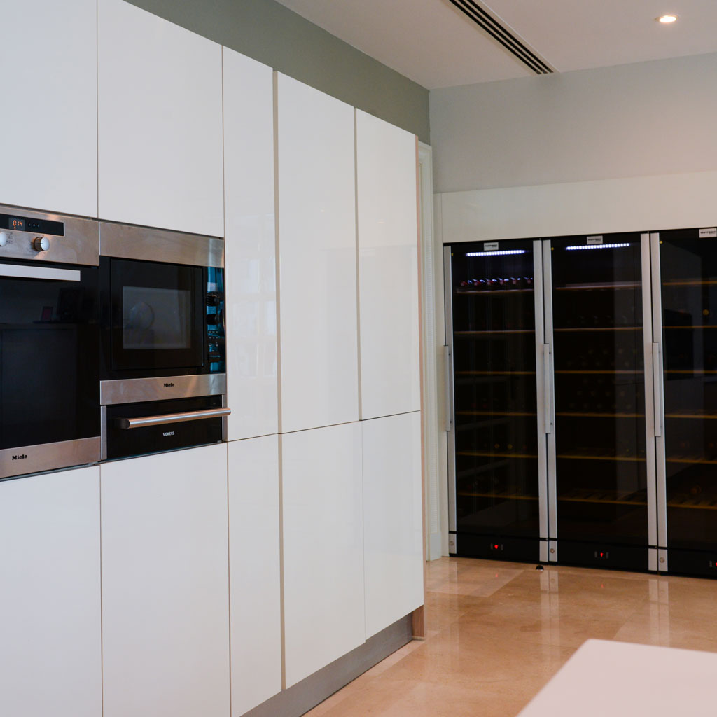 A kitchen room with tall cabinets