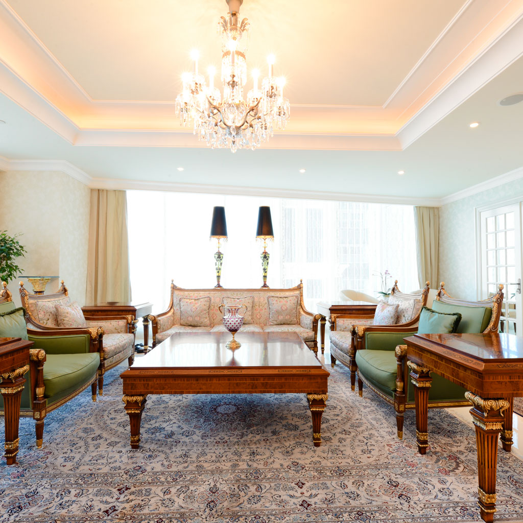 Classical elegance reigns in the palace-style livign room, adorned with ornate accents.