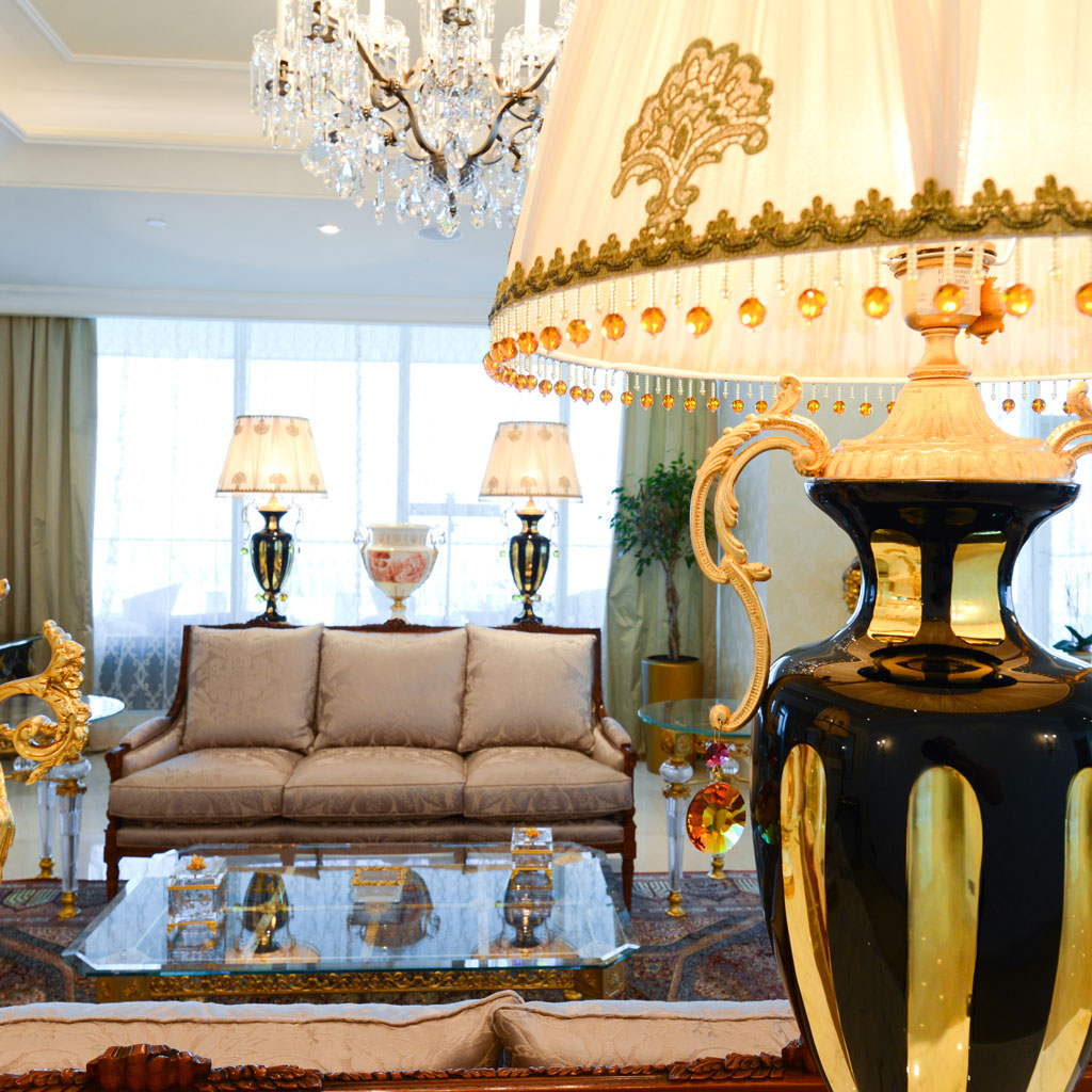 Grand table lamp and gilded accents add a touch of glamour to the classical luxury interior.