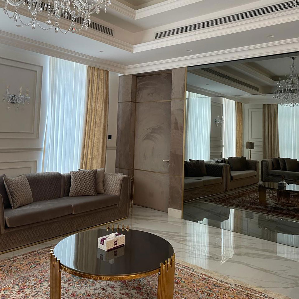 Intricately designed rugs and carpets anchor the space, enhancing its traditional charm.