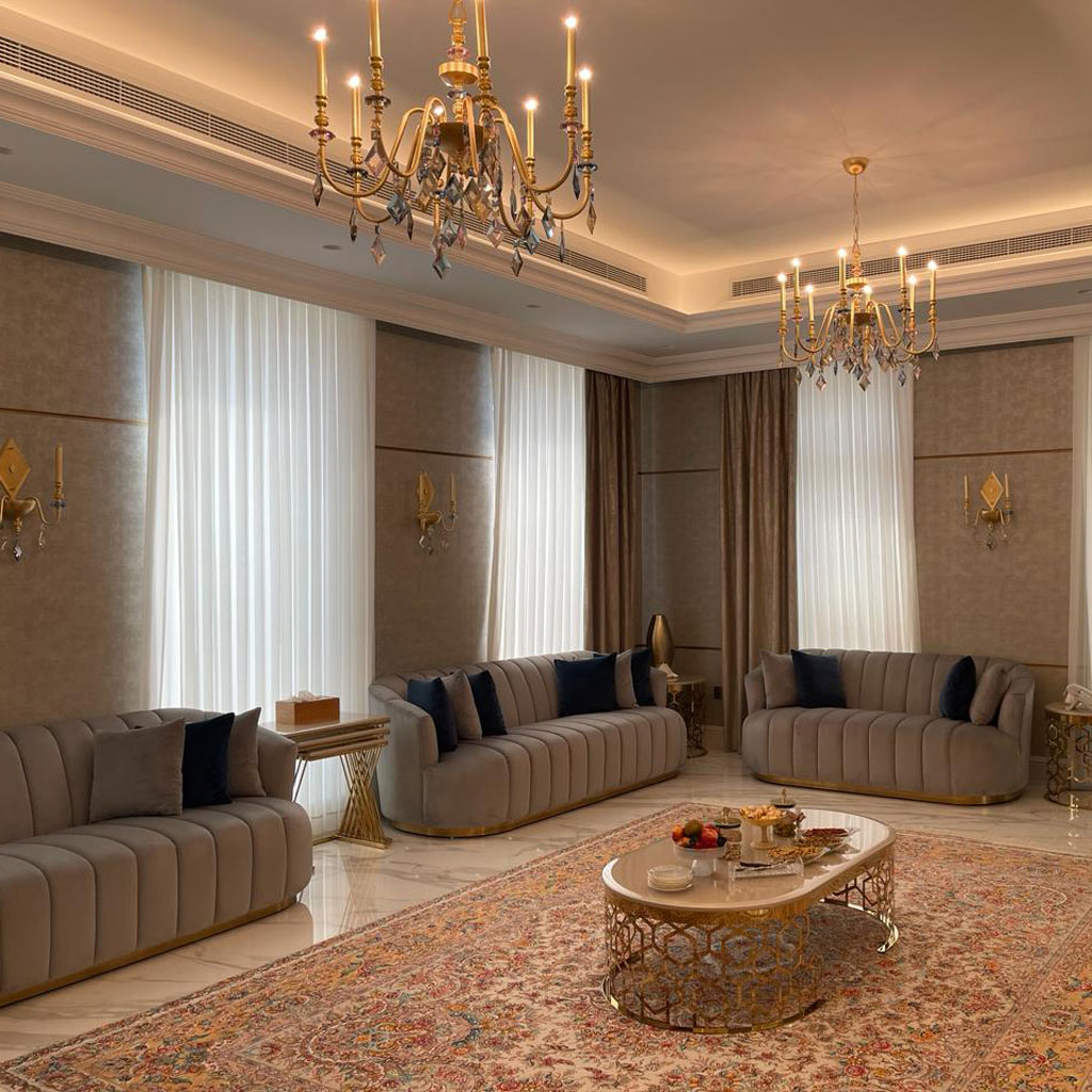 The majlis features low seating arrangements, promoting intimacy and relaxation.