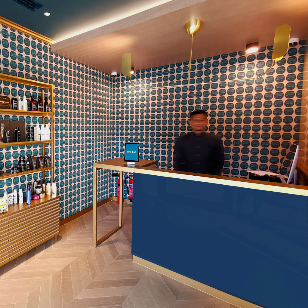 The salon's sleek design includes chic mirrors and stylish hair stations.